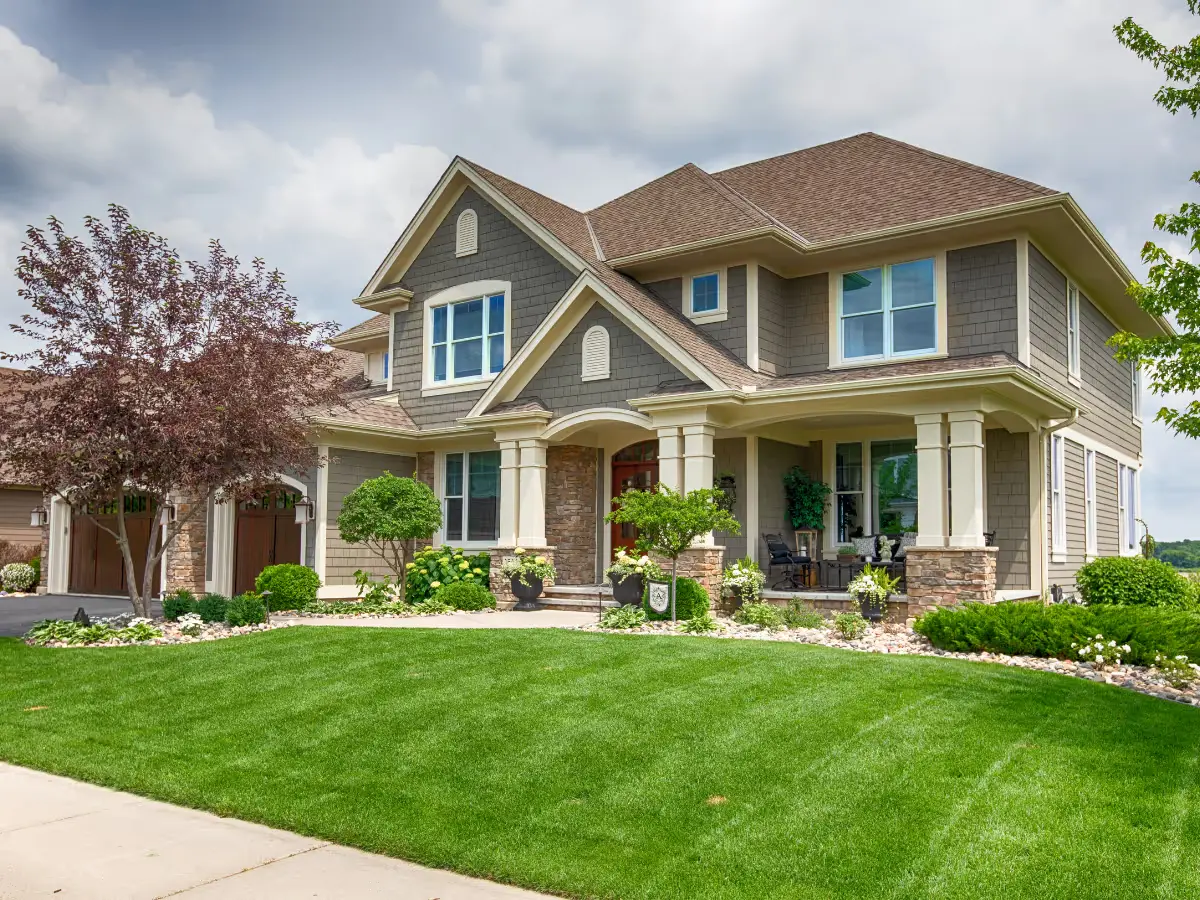 A two-story suburban house seen from the street, the kind of home someone keeps a record of from a thousand miles away